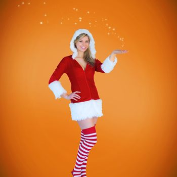 Pretty girl presenting in santa outfit against orange vignette