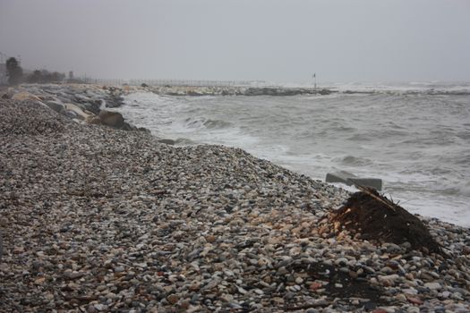 gray storm on small rocks of Liguria in a gloomy tragic day in Italy