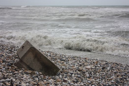 gray storm on small rocks of Liguria in a gloomy tragic day in Italy