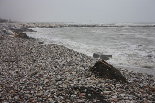 gray storm on small rocks of Liguria in a gloomy tragic day in Italy