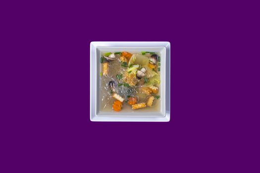 Tom seed tofu. Asian Thai food on white plates with purple background with copy space