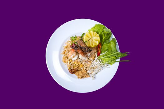 Pad thai. Asian Thai food on white plates with purple background with copy space