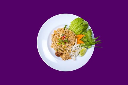 phat thai.Asian Thai food on white plates with purple background with copy space