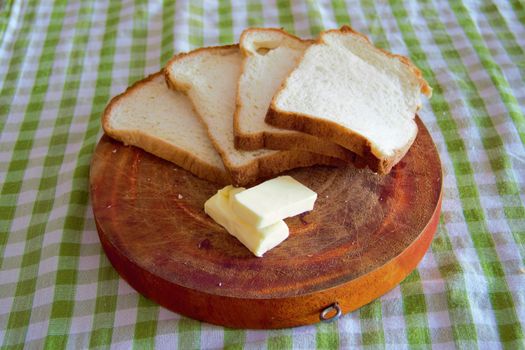 fresh bread on a wooden board with butter