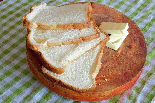 slices of artisan bread with butter on a wooden board