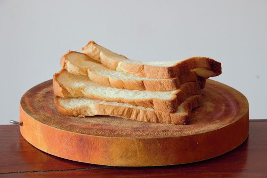 side shot of bread slices on a wooden board