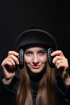 Teen Girl In Hoodie Holding Headphones