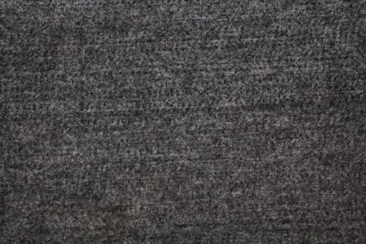 The picture shows a grey textile background with a structure