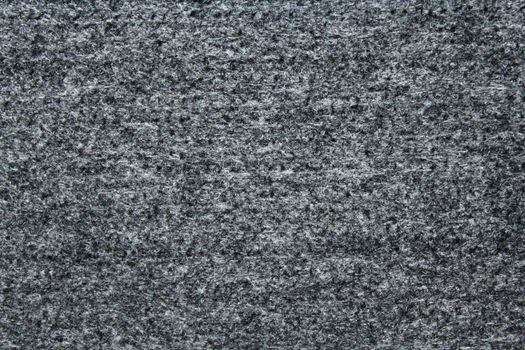 The picture shows a grey textile background with a structure