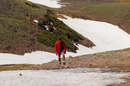A man going for a hike in the Colorado Mountains.