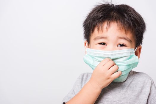 Closeup Asian face, Little children boy sick he using medicine healthcare mask on white background with copy space, health medical care