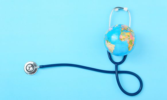 World health day concept, Stethoscope, globe on blue background with copy space. Global health care