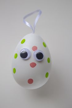 An Easter Egg with a hanger on a white background