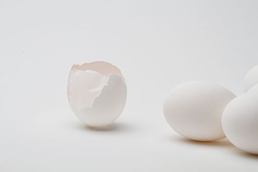 empty broken egg with skin expose, separated from a group of egg
