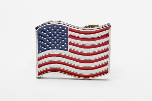 close up of a USA flag pin isolated against a white background