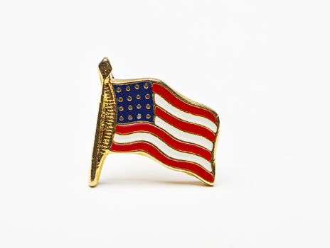 close up of a USA flag pin isolated against a white background