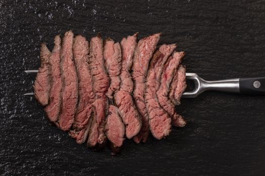 slices of a steak on slate