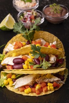 three mexican tacos on slate