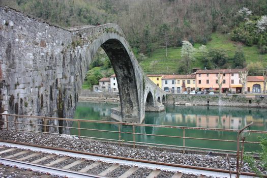 The suggestive and famous Ponte della Maddalena of Lucca built in bricks over a river in an ancient medieval village in Borgo a Mozzano