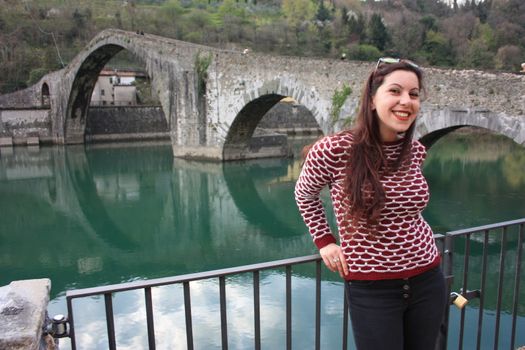 The suggestive and famous Ponte della Maddalena of Lucca built in bricks over a river in an ancient medieval village in Borgo a Mozzano