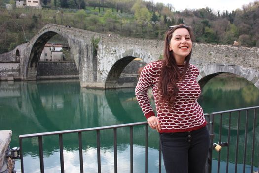 The suggestive and famous Ponte della Maddalena of Lucca built in bricks over a river in an ancient medieval village in Borgo a Mozzano