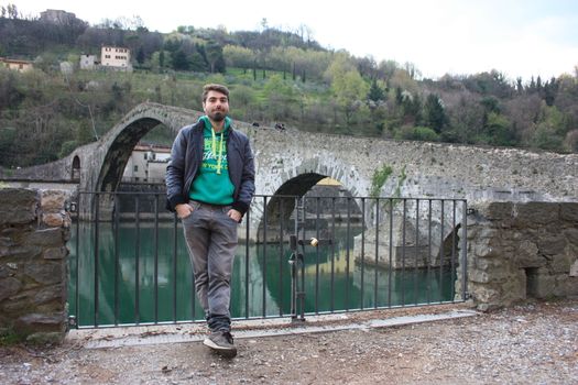 The suggestive and famous Ponte della Maddalena of Lucca built in bricks over a river in an ancient medieval village in Borgo a Mozzano