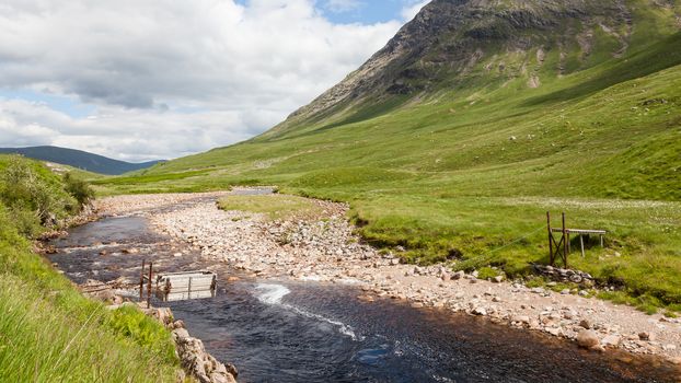 A sheep transporter is pictured crossing the River Etive in Glen Etive, a glen in the Scottish Highlands.