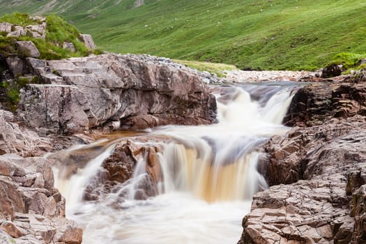 Water cascades down the River Etive in Glen Etive in the Scottish highlands.