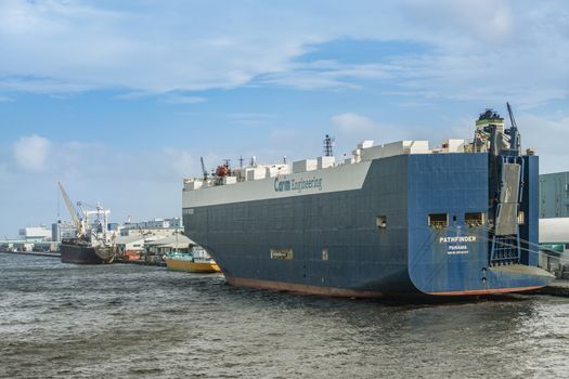 Giant cargo ship with the flag of Panama moored in the commercial port of Tokyo Bay.