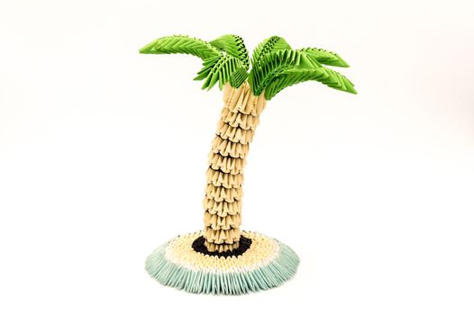 Palm tree constructed from paper on white background