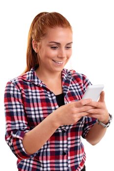 Beautiful smiling young woman looking at mobile phone and reading sms messages or surfing the internet or shopping online or texting, isolated on white background. Technology and social media concept.