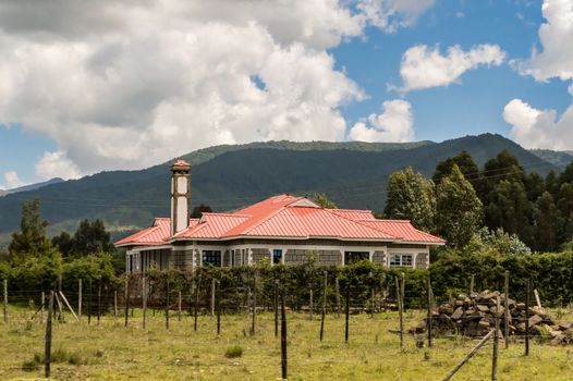 Modern residential house in Africa with a fence. Accommodation in Kenya. Magnificent cityscape.