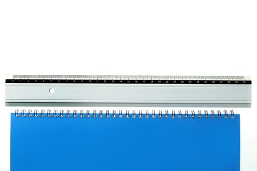 ruler laying straight at bottom of a white and blue page with copy space