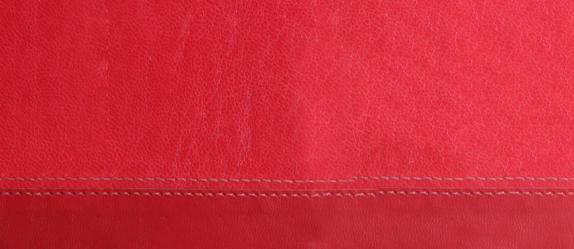 red leather background with red stitches at the bottom
