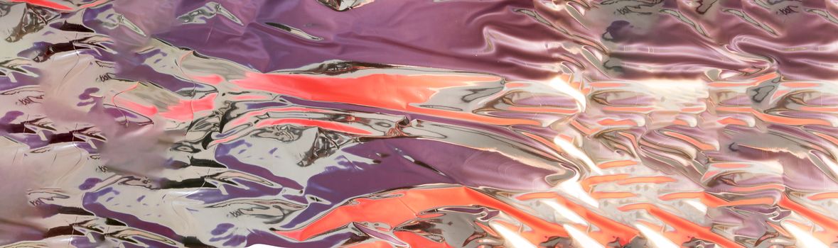 silver - mercury looking background with shinny purple and orange reflection with copy space,