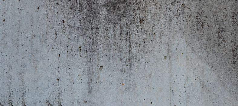 dark grey cement wall with dirt spots for background use.