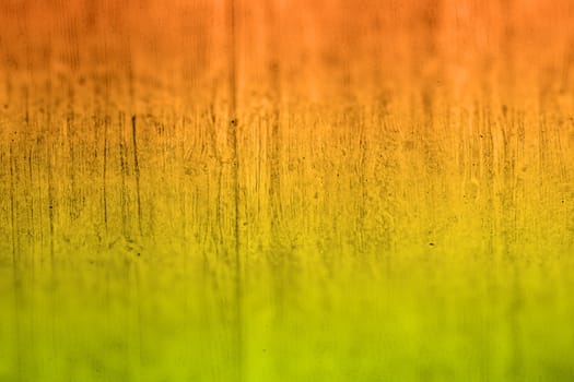 cement wall with copy space for background, colored in in green, yellow, orange