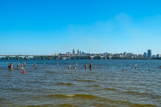 View of the city's waterfront and bridge from the opposite bank of the river.