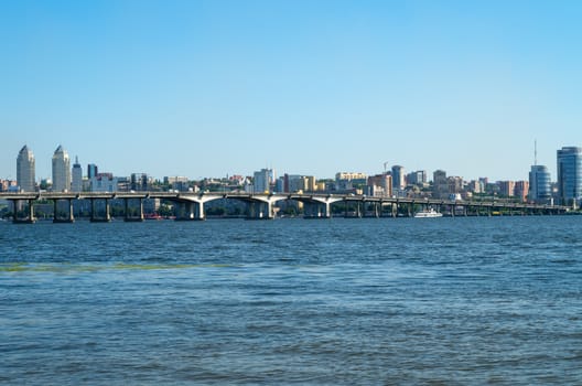 View of the city's waterfront and bridge from the opposite bank of the river.