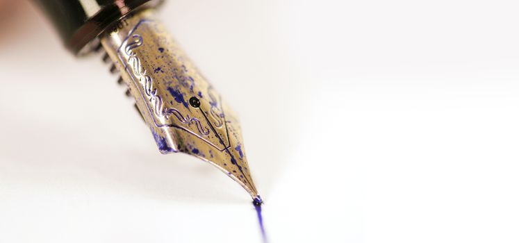 fountain pen with ink on white paper background. White background