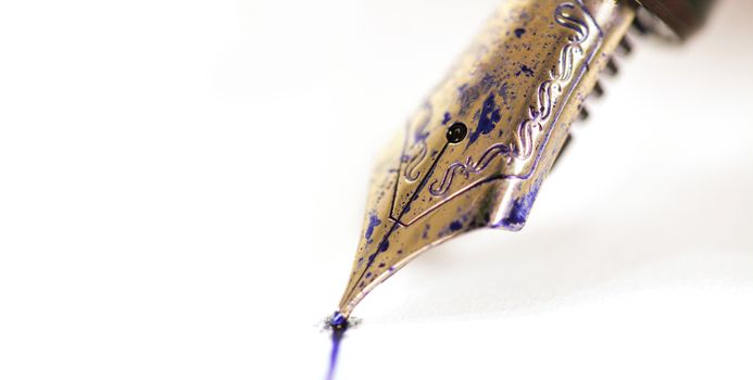 fountain pen with ink on white paper background, with ink drops on white background
