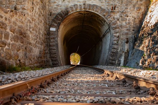 rail road tracks leading into a dark tunnel in Switzerland