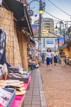 Retro old-fashionned shopping street Yanaka Ginza famous as a spectacular spot for sunset golden hour from the Yuyakedandan stairs which means Dusk Steps at Nishi-Nippori in Tokyo. Yanaka Ginza is also named the Evening Village.