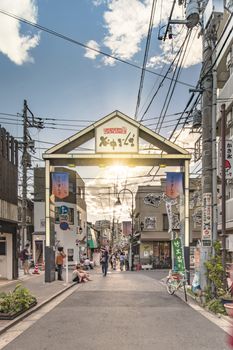The famous Yuyakedandan stairs which means Dusk Steps at Nishi-Nippori in Tokyo. The landscape overlooking Yanaka Ginza from the top of the stairs is famous as a spectacular spot for sunset. Below the stairs there is a gate marked "Yanaka Ginza, the Evening Village".