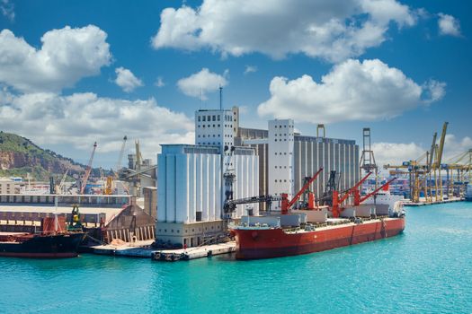 Large old freighters at an industrial shipping harbor in Barcelona, Spain