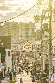 The famous Yuyakedandan stairs which means Dusk Steps at Nishi-Nippori in Tokyo. The landscape overlooking Yanaka Ginza from the top of the stairs is famous for frequently appearing in Yanaka related magazines and programs, and it is also a spectacular spot for sunset. Below the stairs there is a gate marked "Yanaka Ginza".