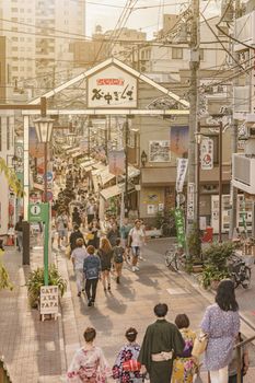 The famous Yuyakedandan stairs which means Dusk Steps at Nishi-Nippori in Tokyo. The landscape overlooking Yanaka Ginza from the top of the stairs is famous as a spectacular spot for sunset. Below the stairs there is a gate marked "Yanaka Ginza, the Evening Village".