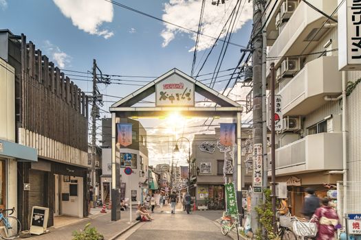 The famous Yuyakedandan stairs which means Dusk Steps at Nishi-Nippori in Tokyo. The landscape overlooking Yanaka Ginza from the top of the stairs is famous as a spectacular spot for sunset. Below the stairs there is a gate marked "Yanaka Ginza, the Evening Village".