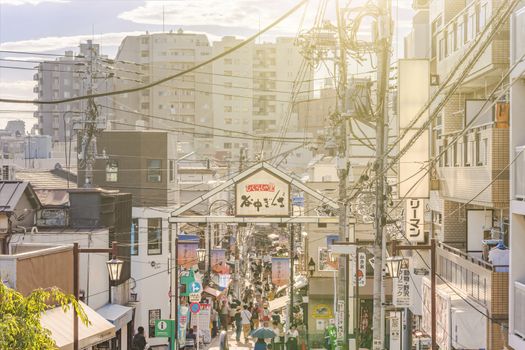 The famous Yuyakedandan stairs which means Dusk Steps at Nishi-Nippori in Tokyo. The landscape overlooking Yanaka Ginza from the top of the stairs is famous for frequently appearing in Yanaka related magazines and programs, and it is also a spectacular spot for sunset. Below the stairs there is a gate marked "Yanaka Ginza".