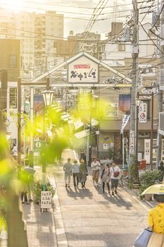 The famous Yuyakedandan stairs which means Dusk Steps at Nishi-Nippori in Tokyo. The landscape overlooking Yanaka Ginza from the top of the stairs is famous as a spectacular spot for sunset. Below the stairs there is a gate marked "Yanaka Ginza, the Evening Village".